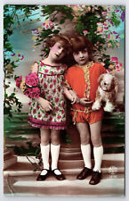 Vintage Colorful Tinted Postcard C1930 Two Lovely Girls Posing with Roses & Dog picture
