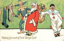 c1910 Christmas Postcard Jester & Clown Hang Socks & Long Underwear for Santa picture