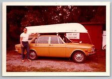 gone fishing bait shop and boat on a 1970 Volvo 144 Vintage Photo 1972 picture