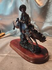 COWBOY ON BUCKING HORSE FIGURINE ON WOODED BASE  picture