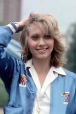 Olivia Newton John smiling pose in blue jacket hand in hair 12x18 poster picture