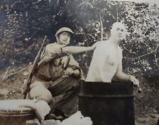 WWII U.S. G.I.  HELPING HIS FRIEND TAKE BATH IN  OIL DRUM.  SMOKING CIGARETTE. picture