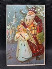 Antique Christmas Greetings Embossed Postcard Santa With Angel Divided Back picture