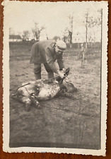 Man slaughtered a pig. Dead pig. It's a scary, strange photo. Vintage photo picture