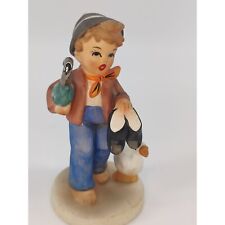 Vintage Little Boy Caring Umbrella and Shoes with Cute Duck Figurine picture