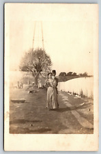 RPPC Young Couple by Power Radio or Phone Tower Construction Real Photo Postcard picture