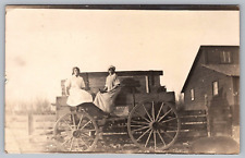 RPPC Two Women Sitting on a Large Wagon Farm House Postcard picture