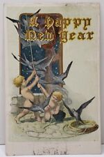 A Happy New Year Cherub Ringing Bell Birds Flying From Bell Gold Postcard A18 picture