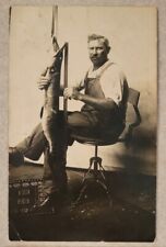 RPPC Fisherman Fishing Measuring Muskie Fish Man Overalls Chair Studio Postcard picture