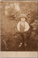 c1910s RPPC Real Photo Postcard Very Cute Child in Garden / Denim Overalls picture