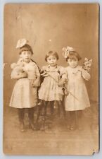 Postcard RPPC Girls with American Flag and Flowers Real Photo Wide Eyed Sisters picture
