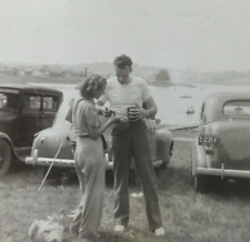 Man & Woman Looking At Hands By Cars In Ohio B&W Photograph 3.5 x 3.5 picture
