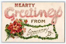 c1910's Hearty Greetings From Sigourney Iowa IA Flowers Embossed Postcard picture