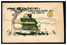 SOMETHING DOING ALL THE TIME IN VINTAGE POSTCARD UNUSED MAN WOMAN HUGGING BENCH picture