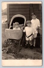 RPPC AZO 1904-1918 Two Young Kids Stand Near Child In Stroller ANTIQUE Postcard picture