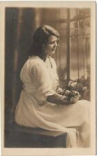 RPPC Young Woman in Studio Holding Flowers c1910 Real Photo Postcard picture