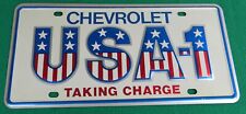 NOS Small Hole Chevrolet USA-1  Taking Charge License Plate picture