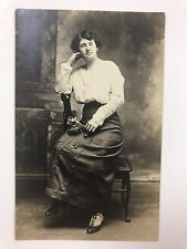 vintage 1915 cute young lady sitting on the arm of the chair RPPC post card picture