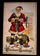 Santa Claus Fills Stocking with Toys~Antique~Christmas Postcard~k-9 picture