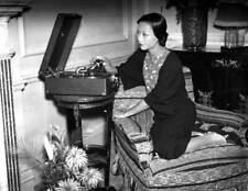 American actress Anna May Wong pictured her home playing a record - 1930s Photo picture