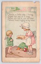c1910s Cupid & Baker Valentines Gift Ring in Cake Antique Art Postcard picture